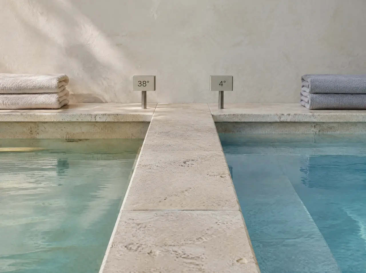 Detail of the shared coping between the warm and cold pools, each with a small display